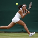 Madison Keys of the United States returns to Mona Barthel of Germany during their Women's second round singles match at the All England Lawn Tennis Championships in Wimbledon, London, Thursday, June 27, 2013. (AP Photo/Sang Tan)