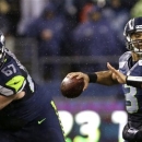 Seattle Seahawks quarterback Russell Wilson throws against the San Francisco 49ers in the first half of an NFL football game, Sunday, Dec. 23, 2012, in Seattle. (AP Photo/Elaine Thompson)