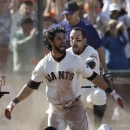San Francisco Giants' Angel Pagan, center, celebrates with Andres Torres after hitting an inside the park two-run home run off of Colorado Rockies pitcher Rafael Betancourt during the tenth inning of a baseball game in San Francisco, Saturday, May 25, 2013. (AP Photo/Jeff Chiu)