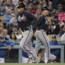 Atlanta Braves' Chipper Jones, left, passes third-base coach Brian Snitker after hitting a home run during the fifth inning of a baseball game against the Los Angeles Dodgers in Los Angeles, Tuesday, April 24, 2012. (AP Photo/Jason Redmond)