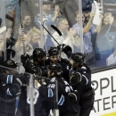 San Jose Sharks center Patrick Marleau center, is mobbed by teammates after scoring the game-winning goal against the Vancouver Canucks during overtime of Game 4 of their first-round NHL hockey Stanley Cup playoff series in San Jose, Calif., Tuesday, May 7, 2013. San Jose won 4-3 in overtime. (AP Photo/Marcio Jose Sanchez)
