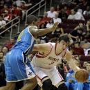 Houston Rockets' Omer Asik (3) drives the ball around New Orleans Hornets' Lance Thomas in the second half of a preseason NBA basketball game Friday, Oct. 12, 2012, in Houston. (AP Photo/Pat Sullivan)