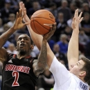 Louisville's Russ Smith (2) drives to the basket past Connecticut's Tyler Olander during the first half of an NCAA college basketball game in Hartford, Conn., Monday, Jan. 14, 2013. (AP Photo/Fred Beckham)