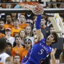Kansas center Jeff Withey (5) dunks against Oklahoma State during the first half of an NCAA college basketball game in Stillwater, Okla., Wednesday, Feb. 20, 2013. (AP Photo/Sue Ogrocki)