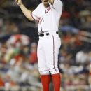 Washington Nationals starting pitcher Stephen Strasburg wipes rain from his brow in the sixth inning of a baseball game against the Atlanta Braves, Friday, July 20, 2012, in Washington. (AP Photo/Carolyn Kaster)