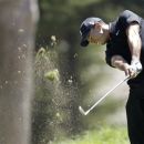 Furyk, McDowell share the lead as Tiger tumbles (The Associated Press)
