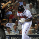 Atlanta Braves' Justin Upton, right, reacts after being hit by a pitch by starting pitcher Ubaldo Jimenez during the fifth inning of a baseball game on Thursday, Aug. 29, 2013, in Atlanta. Upton came out of the game on the play. (AP Photo/John Amis)