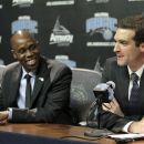 Jacque Vaughn, left, the new head coach of the Orlando Magic NBA basketball team, listens as team general manager Rob Hennigan answers a question at a news conference, Monday, July 30, 2012, in Orlando, Fla. (AP Photo/John Raoux)