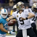 New Orleans Saints quarterback Drew Brees (9) passes as Miami Dolphins outside linebacker Koa Misi (55) rushes in the first half of an NFL football game in New Orleans, Monday, Sept. 30, 2013. (AP Photo/Bill Haber)