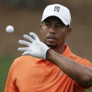 Tiger Woods catches a ball while hitting on the driving range during a practice round for the Masters golf tournament Monday, April 8, 2013, in Augusta, Ga. (AP Photo/Charlie Riedel)