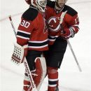 New Jersey Devils' Ilya Kovalchuk, right, of Russia, celebrates with goalie Martin Brodeur after beating the Philadelphia Flyers 4-2 in Game 4 of a second-round NHL hockey Stanley Cup playoff series, Sunday, May 6, 2012 in Newark, N.J. The Devils take a 3-1 lead in the series. (AP Photo/Julio Cortez)