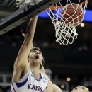 Kansas center Jeff Withey (5) dunks against Western Kentucky center Aleksejs Rostov (20) during the first half of a second-round game in the NCAA college basketball tournament at the Sprint Center in Kansas City, Mo., Friday, March 22, 2013. (AP Photo/Orlin Wagner)