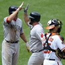 Boston Red Sox's Kelly Shoppach, center, celebrates his two-run home run with teammate Scott Podsednik, left, as Baltimore Orioles catcher Luis Exposito, right, looks on during the sixth inning of a baseball game, Wednesday, May 23, 2012, in Baltimore. The Red Sox won 6-5. (AP Photo/Nick Wass)