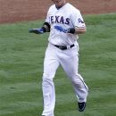 Texas Rangers' Josh Hamilton celebrates as he heads home after hitting a two-run home run off Toronto Blue Jays' Jason Frasor in the 13th inning of a baseball game on Saturday, May 26, 2012, in Arlington, Texas. The hit gave the Rangers a 8-7 walkoff win.  (AP Photo/Tony Gutierrez)