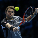 Switzerland's Stanislas Wawrinka plays a return to Czech Republic's Tomas Berdych during their singles ATP World Tour tennis finals match at the O2 arena in London, Monday, Nov. 10, 2014. (AP Photo/Alastair Grant)