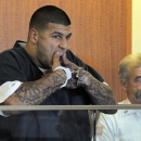 Former New England Patriots football player Aaron Hernandez wipes his mouth while handcuffed during a bail hearing in Fall River Superior Court Thursday, June 27, 2013, in Fall River, Mass. Hernandez, charged with murdering Odin Lloyd, a 27-year-old semi-pro football player, was denied bail. (AP Photo/Boston Herald, Ted Fitzgerald, Pool)