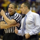 Florida head coach Billy Donovan, right, has a word with referee Steven Anderson, left, during the second half of an NCAA college basketball game at the Pete Maravich Assembly Center in Baton Rouge, La., Saturday, Jan. 12, 2013. Florida won 74-52. (AP Photo/Bill Feig)