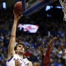 Kansas center Jeff Withey, left, shoots over Oklahoma defenders, including forward Amath M'Baye (22), during the first half of an NCAA college basketball game in Lawrence, Kan., Saturday, Jan. 26, 2013. (AP Photo/Orlin Wagner)