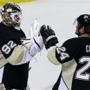 Pittsburgh Penguins goalie Tomas Vokoun (92) celebrates with Matt Cooke (24) after shutting out the New York Islanders 4-0 in Game 5 of an NHL hockey Stanley Cup first-round playoff series, Thursday, May 9, 2013, in Pittsburgh. The Penguins lead the series 3-2. (AP Photo/Gene J. Puskar)