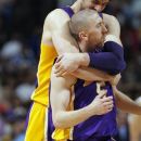 Los Angeles Lakers guard Steve Blake, front, is hugged by forward Pau Gasol, of Spain, after Blake hit a key three-point basket against the Denver Nuggets late in the fourth quarter of the Lakers' 92-88 victory in Game 4 of the teams' first-round NBA  basketball series in Denver on Sunday, May 6, 2012. (AP Photo/David Zalubowski)