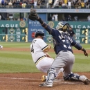 Milwaukee Brewers catcher Martin Maldonado, right, reaches for the throw as Pittsburgh Pirates' Gaby Sanchez, left, scores from third on a pinch-hit by Russell Martin in the fourteenth inning of the baseball game on Sunday, June 30, 2013, in Pittsburgh. The Pirates won 2-1, in 14 innings. (AP Photo/Keith Srakocic)