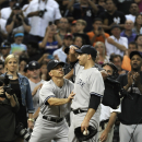 New York Yankees manager Joe Girardi, left, pushes starting pitcher Andy Pettitte back out on the field after beating the Houston Astros 2-1 for his final Major League game Saturday, Sept. 28, 2013, in Houston. Pettitte is retiring after 18 seasons. (AP Photo/Pat Sullivan)