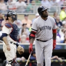 Boston Red Sox's David Ortiz watches his three-run home run off Minnesota Twins starting pitcher Scott Diamond in the first inning of a baseball game, Saturday, May 18, 2013, in Minneapolis. At left is Twins catcher Ryan Doumit. (AP Photo/Jim Mone)