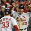 St. Louis Cardinals' David Freese, right, reacts as he and Daniel Descalso score on a single by Pete Kozma in the ninth inning of Game 5 of the National League division baseball series against the Washington Nationals early Saturday, Oct 13, 2012, in Washington. (AP Photo/Nick Wass)