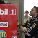 Sprint Cup Series driver Tony Stewart checks his times during practice for the Brickyard 400 auto race at the Indianapolis Motor Speedway in Indianapolis, Friday, July 26, 2013. (AP Photo/Darron Cummings)