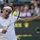 Roger Federer of Switzerland returns to Sergiy Stakhovsky of Ukraine during their Men's second round singles match at the All England Lawn Tennis Championships in Wimbledon, London, Wednesday, June 26, 2013. (AP Photo/Alastair Grant)