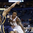 Milwaukee Bucks' Brandon Jennings drives past Indiana Pacers' George Hill during the first half of an NBA basketball game Tuesday, Dec. 18, 2012, in Milwaukee. (AP Photo/Morry Gash)