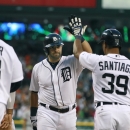 Detroit Tigers' Alex Avila, center, is congratulated by teammates Prince Fielder and Ramon Santiago after his grand slam off Washington Nationals starting pitcher Stephen Strasburg during the sixth inning of a baseball game in Detroit, Tuesday, July 30, 2013. (AP Photo/Carlos Osorio)