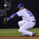Chicago Cubs shortstop Starlin Castro commits an error on a grounder hit by Washington Nationals' Dan Uggla during the sixth inning of a baseball game in Chicago, Wednesday, May 27, 2015. Uggla was safe at first. (AP Photo/Paul Beaty)