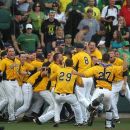 Oregon fans watch with disappointment as Kent State players celebrate a 3-2 victory in the bottom of the ninth inning during the final game of their NCAA college baseball tournament super regional game, Monday, June 11, 2012, in Eugene, Ore. Kent State defeated Oregon 3-2. (AP Photo/The Register-Guard, Brian Davies)