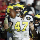 Michigan linebacker Jake Ryan (47) celebrates after recovering a South Carolina fumble during the first half of the Outback Bowl NCAA college football game, Tuesday, Jan. 1, 2013, in Tampa, Fla. (AP Photo/Chris O'Meara)