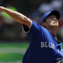 Toronto Blue Jays starting pitcher Chien-Ming Wang delivers to the Texas Rangers in the first inning of a baseball game on Sunday, June 16, 2013, in Arlington, Texas. (AP Photo/Tony Gutierrez)