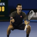 Serbia's Novak Djokovic celebrates his win over Britain's Andy Murray in the men's final at the Australian Open tennis championship in Melbourne, Australia, Sunday, Jan. 27, 2013. (AP Photo/Dita Alangkara)