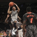 Georgetown's Otto Porter Jr. (22) goes up as Cincinnati's Cashmere Wright (1) looks on during the first half of an NCAA college basketball game at the Big East Conference tournament, Thursday, March 14, 2013 in New York. Georgetown won 62-43. (AP Photo/Mary Altaffer)