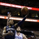 Memphis Grizzlies' Rudy Gay, left, drives to the basket past Philadelphia 76ers' Spencer Hawes (00) during the first half of an NBA basketball game, Monday, Jan. 28, 2013, in Philadelphia. (AP Photo/Matt Slocum)
