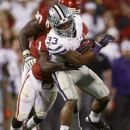 Kansas State runing back John Hubert (33) fights off a tackle by Oklahoma defender Tony Jefferson (1) in the fourth quarter of an NCAA college football game in Norman, Okla., Saturday, Sept. 22, 2012. Kansas State won 24-19. (AP Photo/Sue Ogrocki)