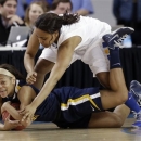 West Virginia guard Christal Caldwell, bottom, tries to protect the ball from Delaware guard Jaquetta May during the first half of a first-round game in the women's NCAA college basketball tournament in Newark, Del., Sunday, March 24, 2013. (AP Photo/Patrick Semansky)