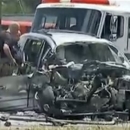 In this image taken from video, emergency personnel work the scene of a car crash Friday, May 31, 2013, in Jonesboro, Ga. Former NBA All-Star guard Daron 