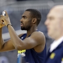CORRECTS CITY TO ARLINGTON, TEXAS; NOT DALLAS - Michigan's Tim Hardaway Jr. takes pictures  during practice for a regional semifinal game in the NCAA college basketball tournament, Thursday, March 28, 2013, in Arlington, Texas. Michigan faces Kansas on Friday. (AP Photo/David J. Phillip)