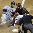 Arizona Diamondbacks catcher Miguel Montero, right, tags out San Diego Padres' Yonder Alonso at the plate during the fifth inning of a baseball game, Saturday, May 25, 2013, in Phoenix. (AP Photo/Matt York)