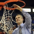 Florida head coach Billy Donovan tugs on the net as he cuts it down following Florida's defeat of Vanderbilt 64-40 in an NCAA college basketball game in Gainesville, Fla., Wednesday, March 6, 2013. (AP Photo/Phil Sandlin)