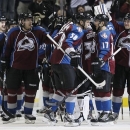 Colorado Avalanche left wing Patrick Bordeleau, front left, congratulates teammate Aaron Palushaj as they join teammates to celebrate the Avalanche's 6-2 victory over the Chicago Blackhawks in an NHL hockey game in Denver on Friday, March 8, 2013. Chicago's loss was its first in regulation this season. (AP Photo/David Zalubowski)