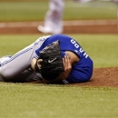 Toronto Blue Jays starting pitcher J.A. Happ reacts after being hit in the head with a line drive off the bat of Tampa Bay Rays' Desmond Jennings during the second inning of a baseball game Tuesday, May 7, 2013, in St. Petersburg, Fla. (AP Photo/Mike Carlson)