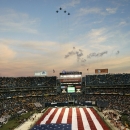 Camp Pendleton Marines hold a large U.S. flag across the field as Navy F-18 fighter jets fly over before the Holiday Bowl football game between Texas and Arizona State on Thursday, Dec, 27, 2007, in San Diego. (AP Photo/Lenny Ignelzi)