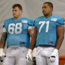 FILE - In this July 24, 2013 file photo, Miami Dolphins guard Richie Incognito (68) and tackle Jonathan Martin (71) stand on the field during an NFL football practice in Davie, Fla. Two people familiar with the situation say suspended Dolphins guard Incognito sent text messages to teammate Jonathan Martin that were racist and threatening. The people spoke to The Associated Press on condition of anonymity because the Dolphins and NFL haven't disclosed the nature of the misconduct that led to Incognito's suspension. Martin remained absent from practice Monday, Nov. 4, 2013, one week after he suddenly left the team. (AP Photo/Lynne Sladky, File)