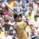 Milwaukee Brewers' Ryan Braun pops foul against the Philadelphia Phillies during the first inning of a baseball game Sunday, June 9, 2013, in Milwaukee. (AP Photo/Tom Lynn)